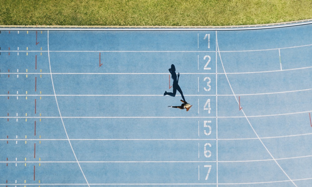 a runner on a blue race track 