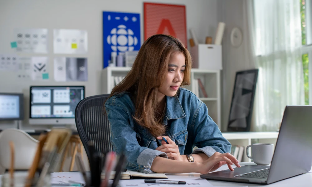 Woman working on computer in a graphic design office